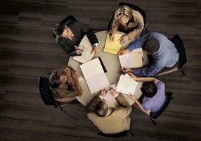 Birds-eye-view-of-business-people-sitting-round-a-table